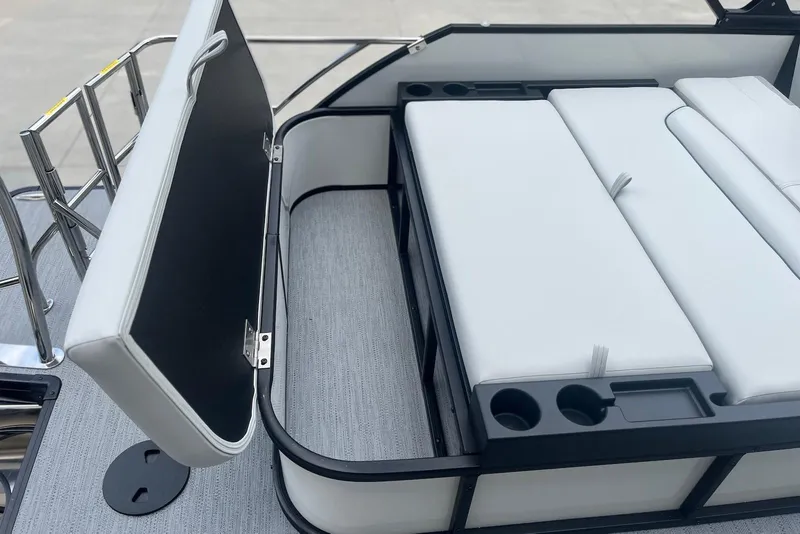 Slide: The Image of 2026 Godfrey SWEETWATER 2286 SFL boat interior with white cushioned seating and cup holders. - 22