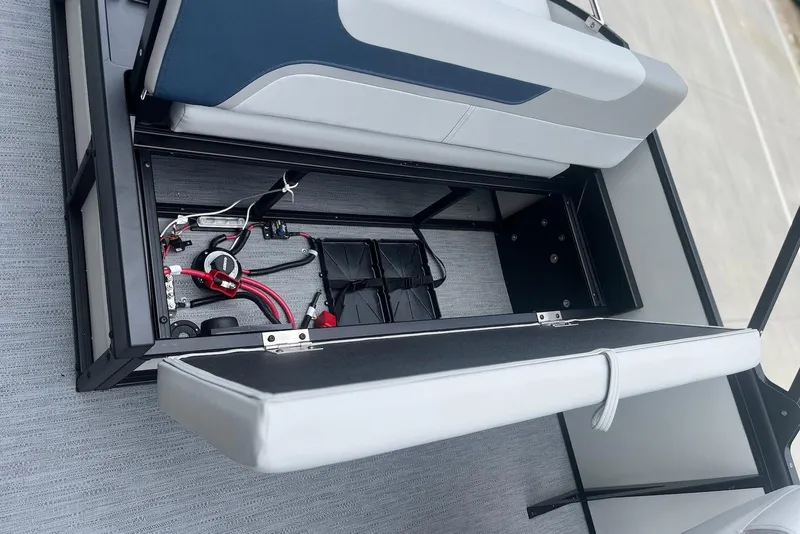 Slide: The Image of Open storage compartment in 2026 Godfrey SWEETWATER 2286 SFL boat, revealing wiring and components. - 24