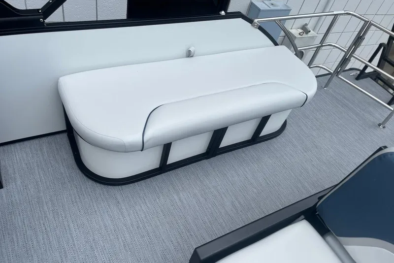 Slide: The Image of 2026 Godfrey SWEETWATER 2286 SFL boat interior with white cushioned seating. - 25