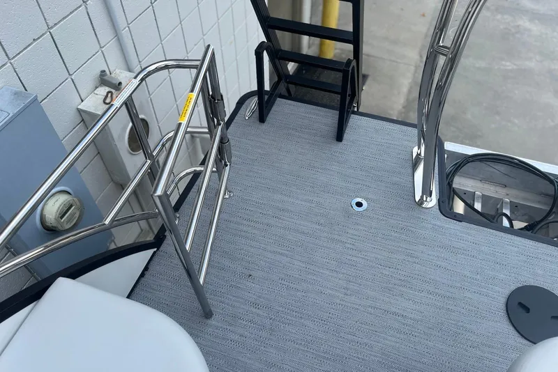 Slide: The Image of 2026 Godfrey SWEETWATER 2286 SFL boat deck with stainless steel railings and ladder. - 27