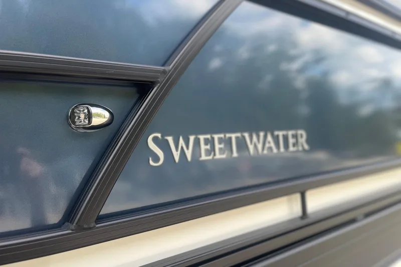 Slide: The Image of 2026 Godfrey SWEETWATER 2286 SFL boat exterior with logo detail. - 5