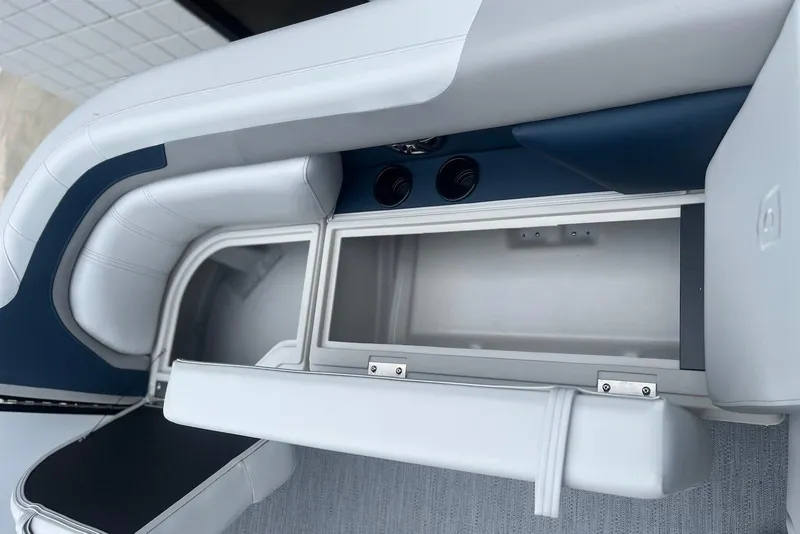 Slide: The Image of Interior storage compartment of 2026 Godfrey SWEETWATER 2286 SFL boat, featuring cushioned seating. - 8