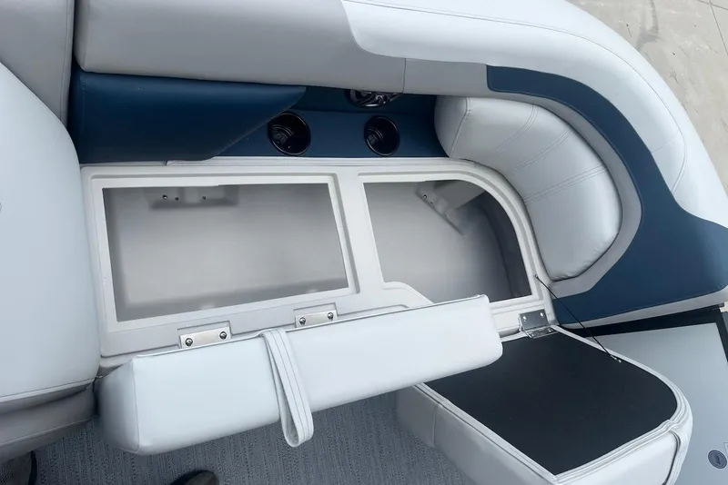 Slide: The Image of 2026 Godfrey SWEETWATER 2286 SFL boat seat storage compartment, open and empty. - 9