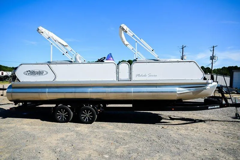 Slide: The Image of 2023 Aloha Pontoon Mahalo 23 on trailer, silver and white design, sunny day. - 0
