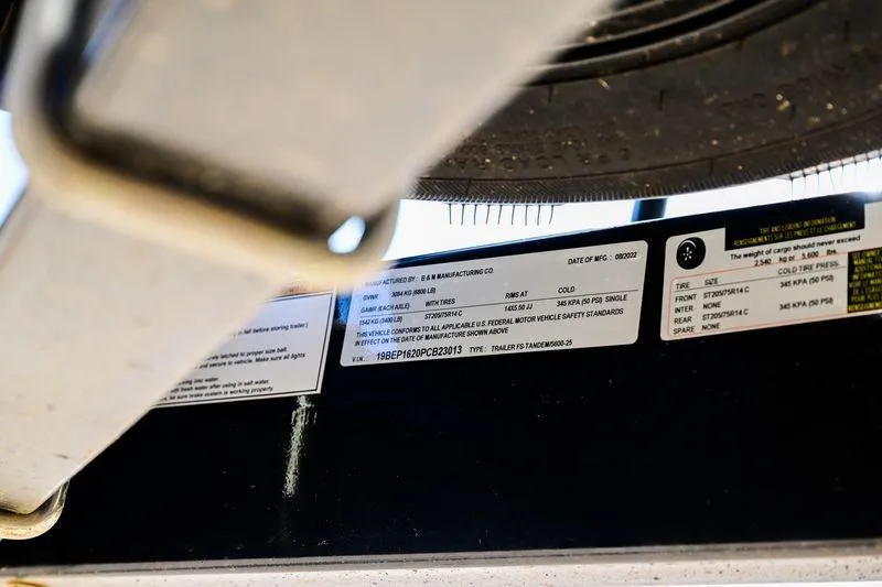 Slide: The Image of Close-up of a 2023 Aloha Pontoon Mahalo 23 trailer label and tire information. - 11