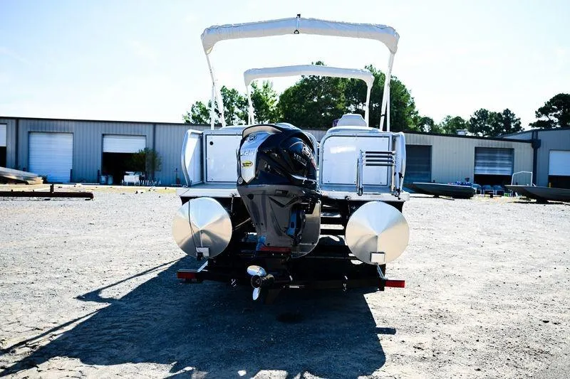 Slide: The Image of 2023 Aloha Pontoon Mahalo 23 boat with outboard motor, parked outdoors. - 3