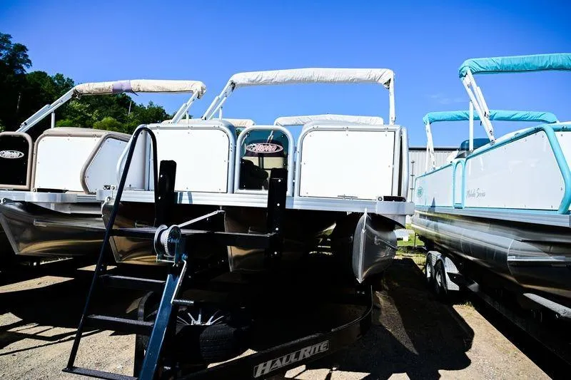 Slide: The Image of 2023 Aloha Pontoon Mahalo 23 boats on trailers under clear blue sky. - 4