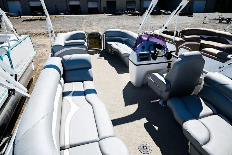 Slide: The Image of 2023 Aloha Pontoon Mahalo 23 interior with spacious seating and modern helm. - 7