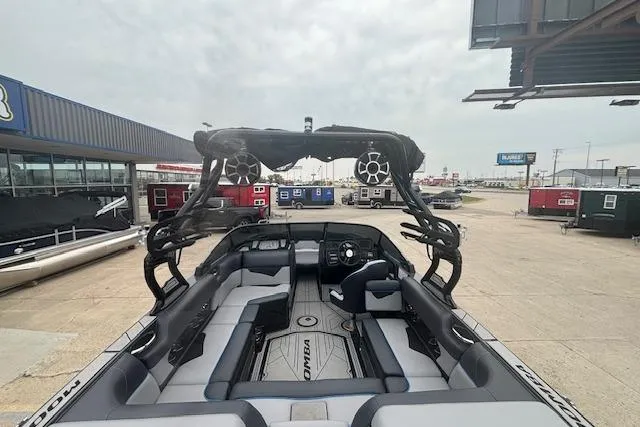 Slide: The Image of 2022 Moomba Kaiyen boat interior with sleek seating and advanced audio system. - 11