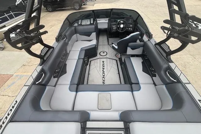 Slide: The Image of 2022 Moomba Kaiyen boat interior with spacious seating and modern dashboard design. - 14