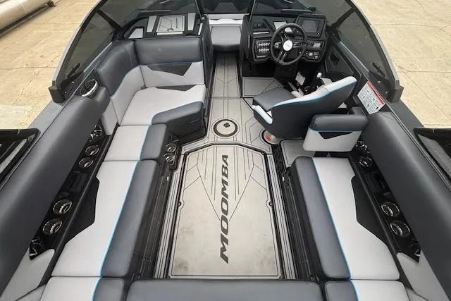 Slide: The Image of 2022 Moomba Kaiyen boat interior with sleek seating and modern dashboard design. - 15