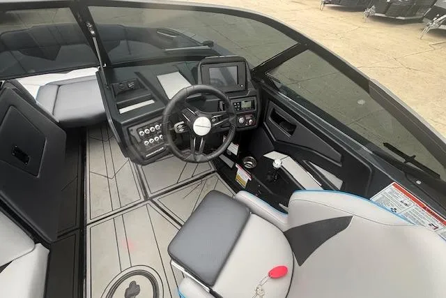 Slide: The Image of 2022 Moomba Kaiyen boat interior with steering wheel and control panel. - 17