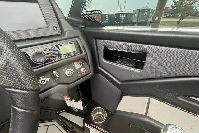 Slide: The Image of 2022 Moomba Kaiyen boat dashboard with control panel and cup holder. - 18