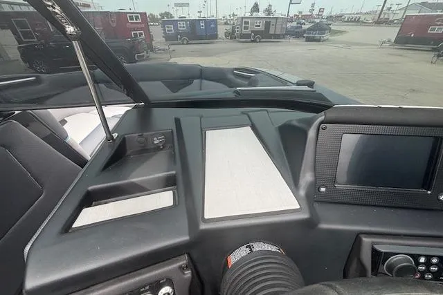 Slide: The Image of 2022 Moomba Kaiyen boat dashboard with modern controls and display screen. - 21