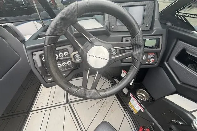 Slide: The Image of 2022 Moomba Kaiyen boat dashboard with steering wheel and control panel. - 22