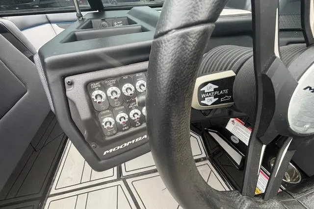 Slide: The Image of 2022 Moomba Kaiyen dashboard with control panel and steering wheel detail. - 23