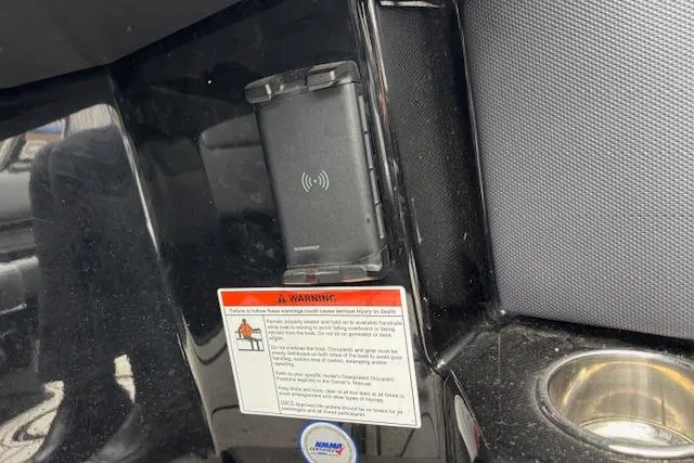 Slide: The Image of 2022 Moomba Kaiyen interior with wireless charger and warning label. - 28