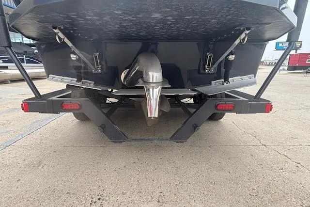 Slide: The Image of 2022 Moomba Kaiyen boat on trailer, rear view showing propeller and hull details. - 3