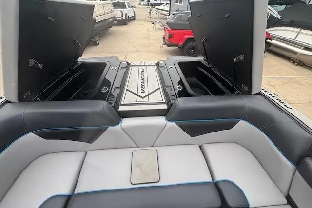 Slide: The Image of 2022 Moomba Kaiyen boat interior with open storage compartments and cushioned seating. - 35