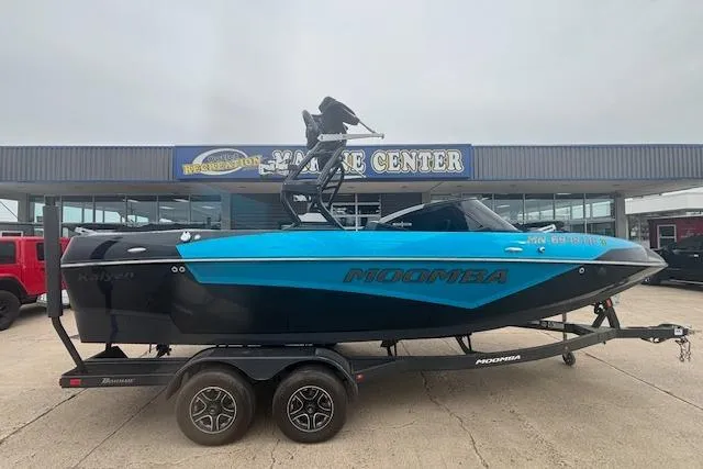 Slide: The Image of 2022 Moomba Kaiyen boat on trailer outside a marine center. - 4