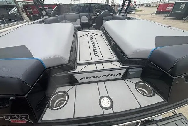 Slide: The Image of 2022 Moomba Kaiyen boat interior with cushioned seating and cup holders. - 7