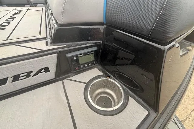 Slide: The Image of 2022 Moomba Kaiyen boat interior with control panel and cup holder. - 8