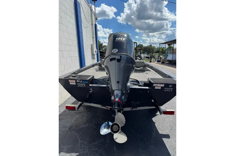 Slide: The Image of 2023 G3 Sportsman 1710 boat with 90 HP motor, parked outdoors. - 4