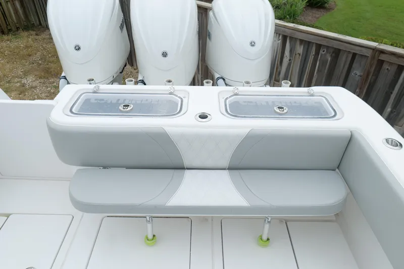 Slide: The Image of 2024 Contender 35 ST boat with triple outboard engines and cushioned seating. - 10