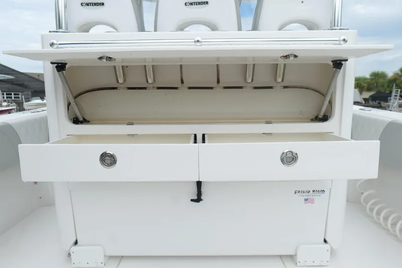 Slide: The Image of 2024 Contender 35 ST boat storage compartment with open drawers and seating. - 14