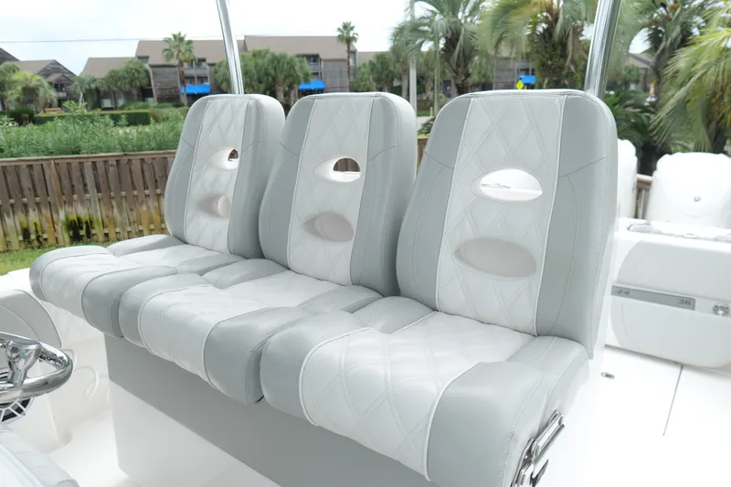 Slide: The Image of 2024 Contender 35 ST boat with luxurious, diamond-stitched seating in a tropical setting. - 17
