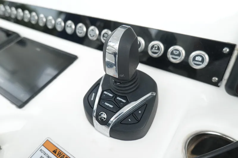Slide: The Image of 2024 Contender 35 ST boat control panel with joystick and buttons. - 19