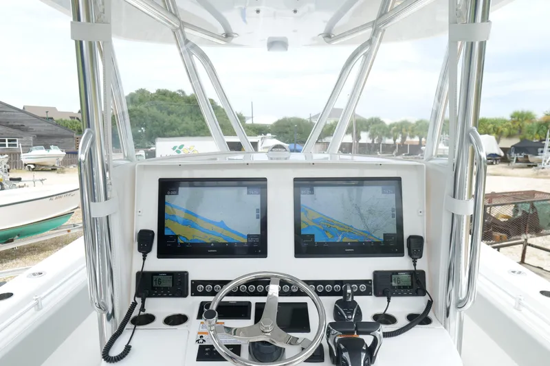 Slide: The Image of 2024 Contender 35 ST boat dashboard with dual navigation screens and controls. - 21