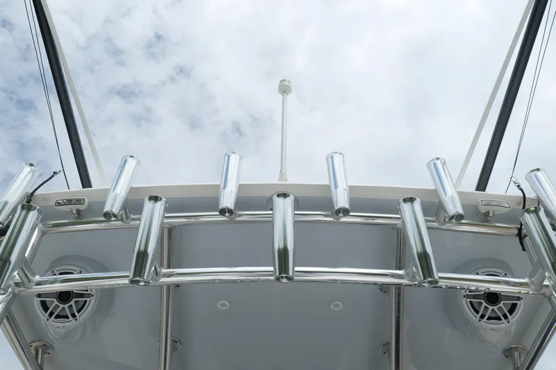 Slide: The Image of 2024 Contender 35 ST boat with rod holders and speakers against cloudy sky. - 23