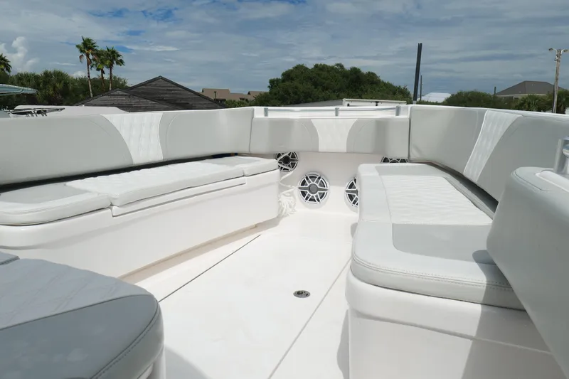 Slide: The Image of 2024 Contender 35 ST boat interior with white cushioned seating and speakers. - 27