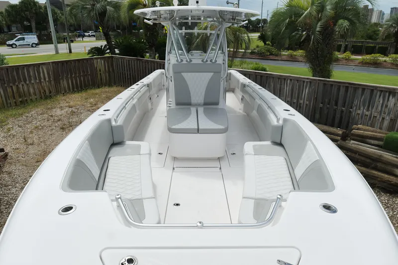 Slide: The Image of 2024 Contender 35 ST boat with spacious seating and sleek design, surrounded by palm trees. - 28