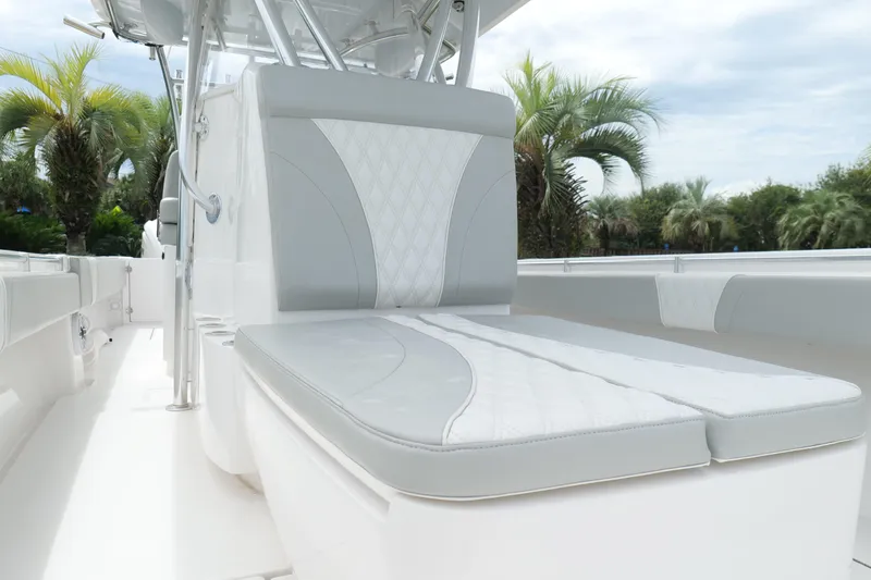 Slide: The Image of 2024 Contender 35 ST boat interior with sleek seating and palm trees in the background. - 29