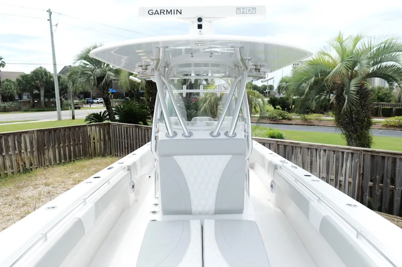 Slide: The Image of 2024 Contender 35 ST boat with Garmin equipment, docked near palm trees. - 30