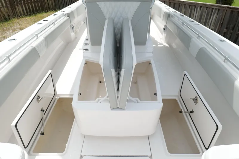 Slide: The Image of 2024 Contender 35 ST boat interior with open storage compartments and seating. - 33
