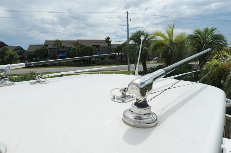 Slide: The Image of 2024 Contender 35 ST boat with antennas, surrounded by palm trees and buildings. - 35