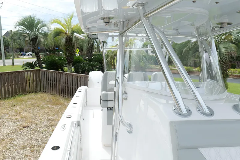 Slide: The Image of 2024 Contender 35 ST boat with sleek design, parked near palm trees. - 39