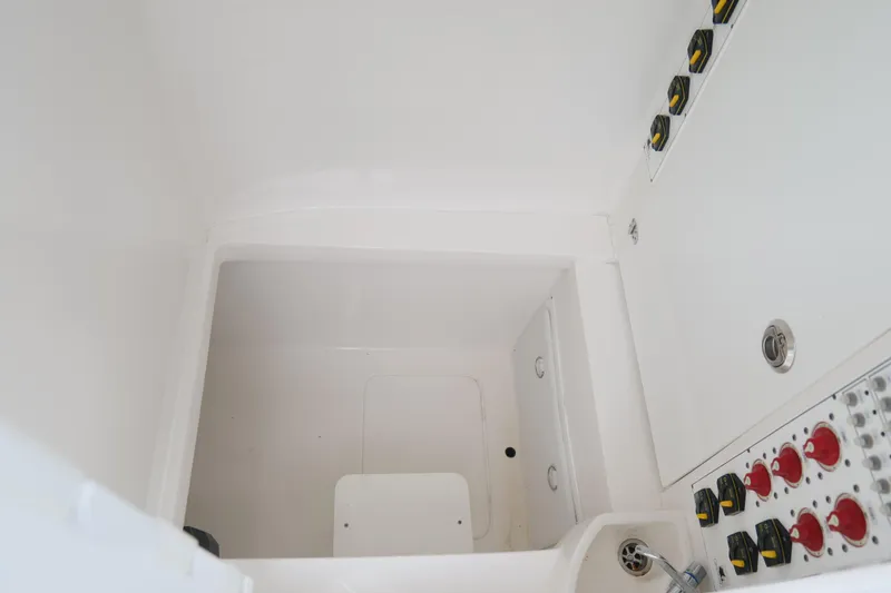 Slide: The Image of 2024 Contender 35 ST boat interior with control panel and storage compartment. - 42