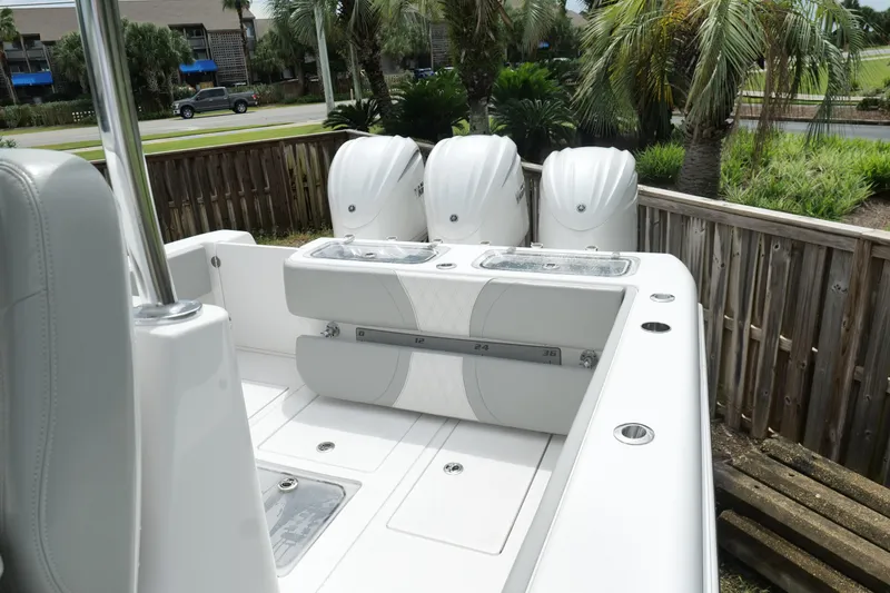 Slide: The Image of 2024 Contender 35 ST boat with triple engines, sleek design, and spacious deck. - 8