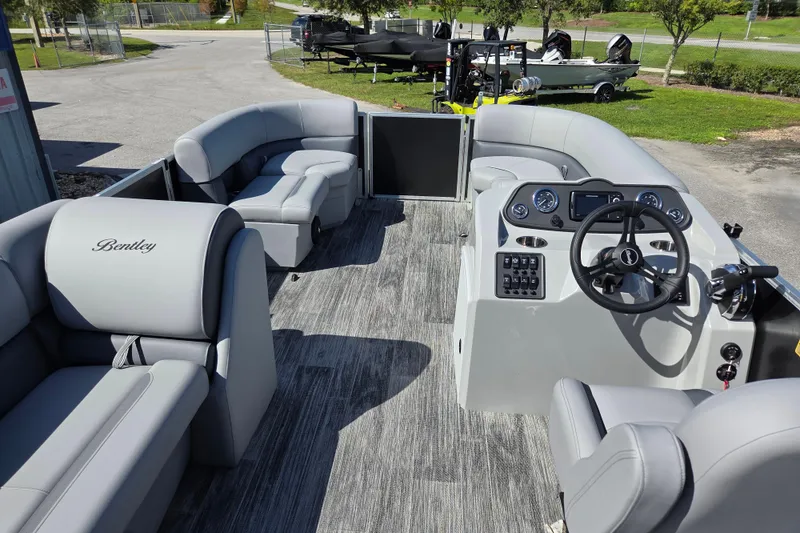Slide: The Image of 2026 Bentley Pontoons LE 180 Cruise interior with modern dashboard and plush seating. - 13