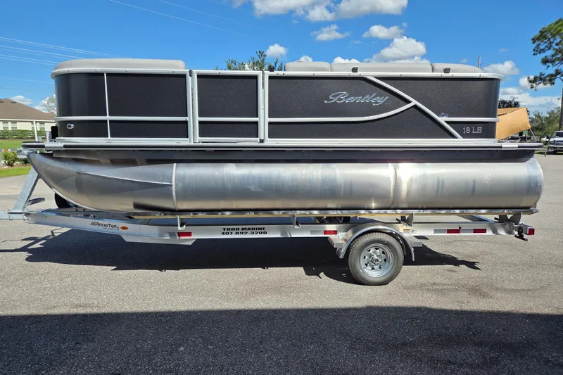 Slide: The Image of 2026 Bentley Pontoons LE 180 Cruise on trailer under clear blue sky. - 5