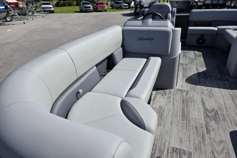Slide: The Image of 2026 Bentley Pontoons LE 180 Cruise interior with luxurious gray seating. - 7