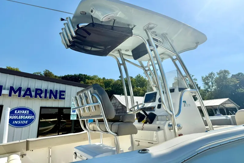 Slide: The Image of 2022 Key West 219 FS boat with T-top and console, displayed at a marine dealership. - 11