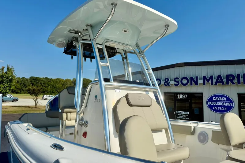 Slide: The Image of 2022 Key West 219 FS boat at a marina, featuring comfortable seating and a sturdy T-top. - 12