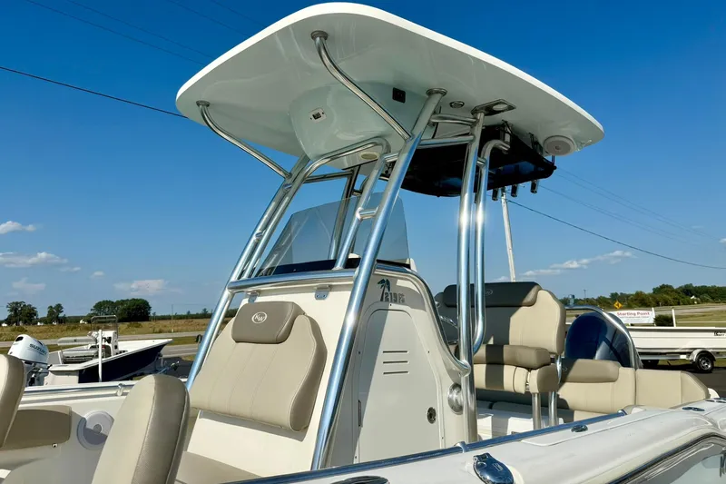 Slide: The Image of 2022 Key West 219 FS boat with T-top and seating, under clear blue sky. - 13