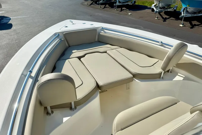 Slide: The Image of 2022 Key West 219 FS boat interior with beige cushioned seating and stainless steel railings. - 14