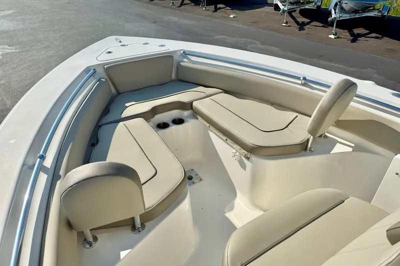 Slide: The Image of 2022 Key West 219 FS boat interior with beige seating and cup holders. - 16